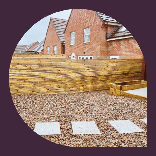 Horizontal redwood slatted fence installed along a property boundary.