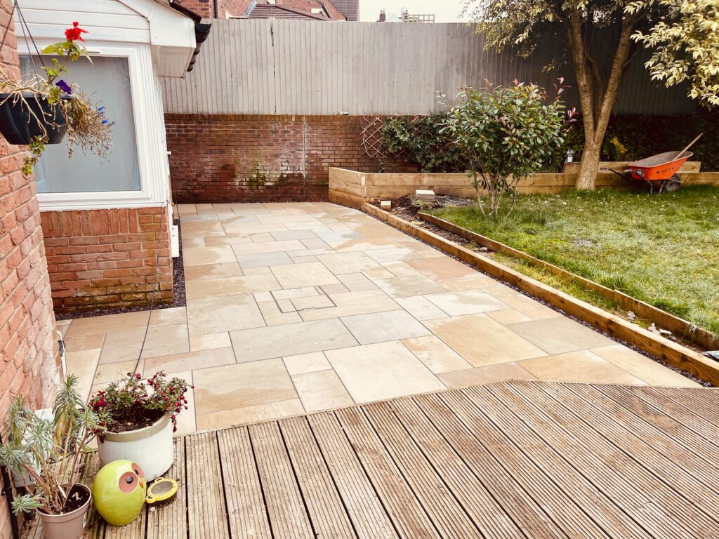 After garden transformation with porcelain paving, raised lawn edge and modern patio installed by Gaia Crafted Landscapes