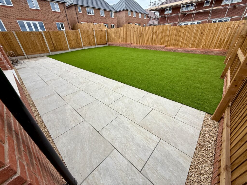 Landscaped new-build garden with porcelain paving and artificial grass lawn