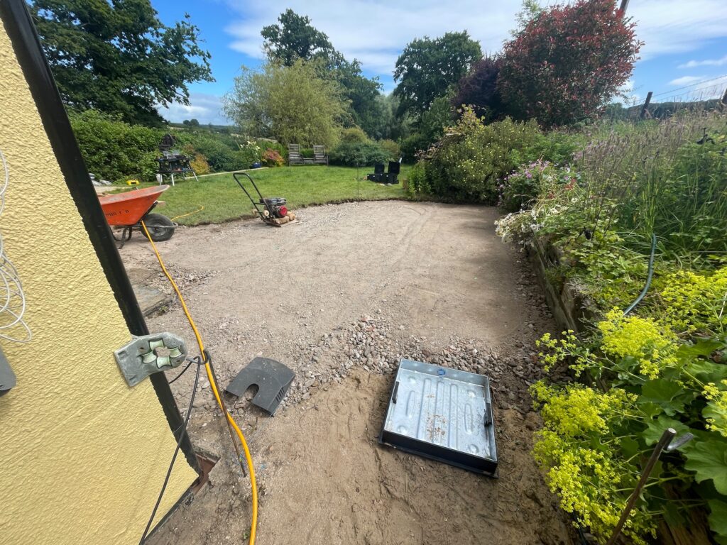 Before image of garden with exposed sub-base and groundwork preparation
