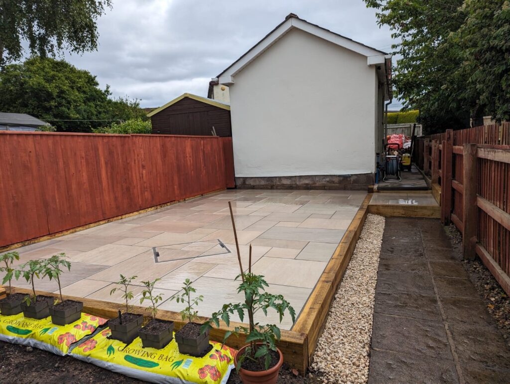 After garden transformation with raised porcelain patio and timber edging installed